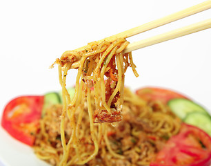 Image showing Eating noodles with chopsticks