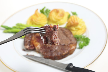 Image showing Eating ribeye steak