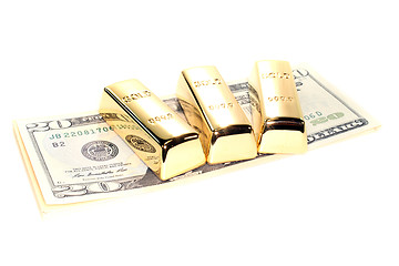 Image showing three gold bars on dollar bills