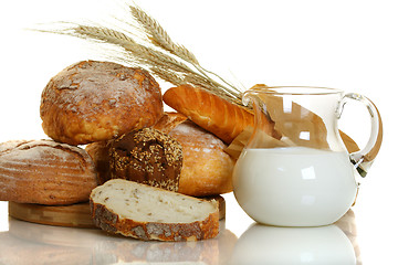 Image showing Fresh bread and milk in a glass jar.