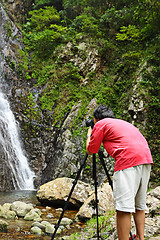 Image showing photographer taking picture of waterfall