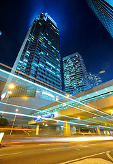 Image showing light trails on the modern building background