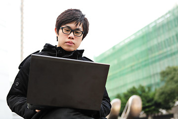 Image showing man using computer outdoor