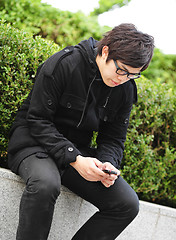 Image showing man sms on cell phone