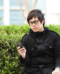 Image showing man sms on cell phone