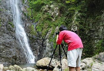 Image showing photographer taking picture of waterfall