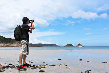 Image showing Photographer taking photo on beach