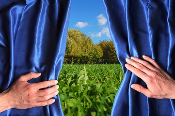 Image showing landscape behind blue curtain