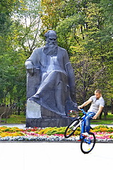 Image showing cyclist next to the monument of the writer Lev Tolstoy