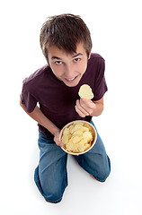 Image showing Boy eating potato crisp chip snack