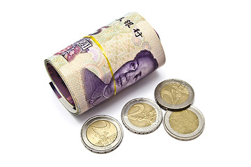 Image showing Roll of chinese money and euro coins