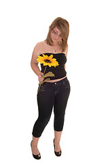 Image showing Teen holding sunflower.