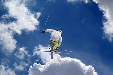 Image showing Freestyle ski jumper with crossed skis
