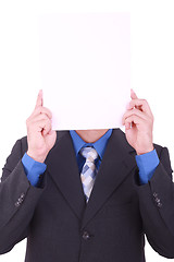 Image showing A businessman with a blank paper in his face isolated on white 