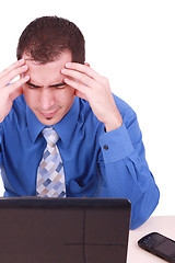 Image showing male frustrated with work sitting in front of a laptop. 