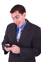 Image showing young and smiling man looking at his cellphone 