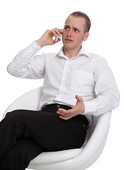 Image showing A businessman in a conversation on the phone solves the problem