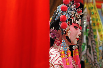 Image showing chinese opera dummy and red cloth as text space ,it is a toy,not