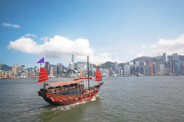 Image showing Junk boat with tourists in Hong Kong Victoria Harbour