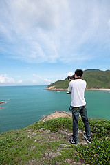 Image showing photographer takes a photo of the landscape 