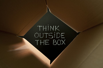 Image showing Think outside the box on blackboard