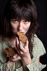 Image showing beggar woman eating bread 