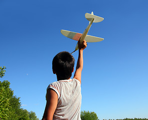 Image showing boy running airplane model