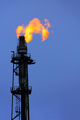 Image showing torch is lit on tower refinery