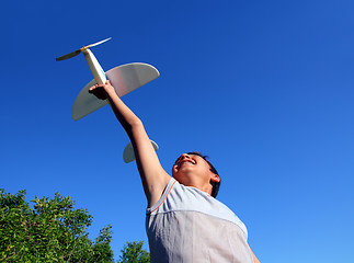 Image showing boy running airplane model