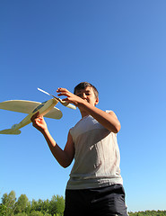 Image showing boy running airplane model
