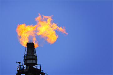 Image showing torch is lit on tower refinery