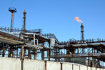 Image showing torch is lit on tower refinery