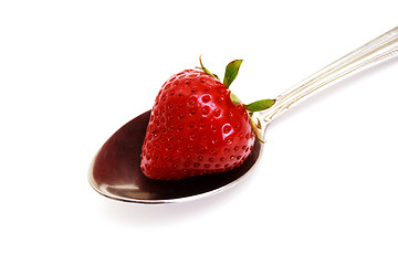 Image showing Zoomed foto of strawberry lying on spoon