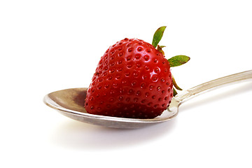 Image showing Zoomed foto of strawberry lying on spoon