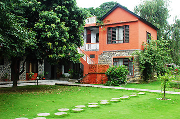 Image showing Red house with green meadows