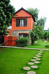 Image showing Red house with green meadows