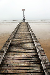 Image showing Teenage girl on old sea pier