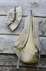 Image showing Khaki Hat and Backpack on the Wooden Wall