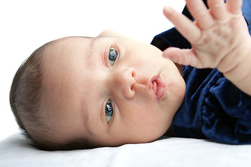 Image showing Cute Baby Curiously Looking at her Hand