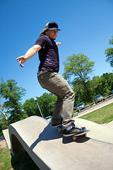 Image showing Skateboarder Rail Grinding at a Concrete Skate Park