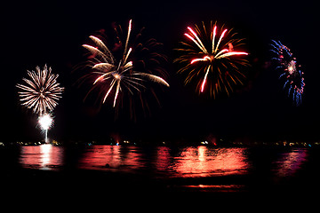 Image showing Fireworks Grand Finale Over Water with Reflections