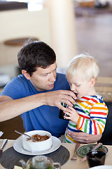 Image showing father and son having a breakfast