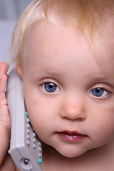 Image showing Baby play with remote control