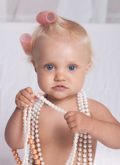 Image showing babe with curlers asked to wear a necklace 