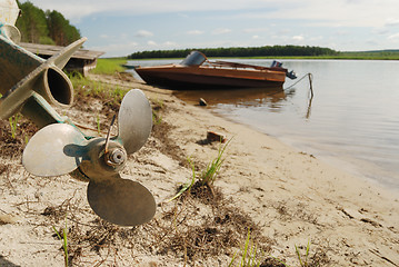Image showing screw propeller, motor boats on the shore