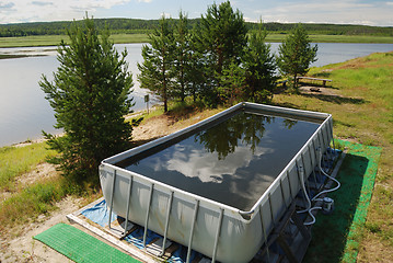 Image showing inflatable pool in the camp by the river