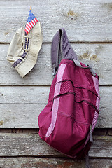 Image showing Khaki Hat, US flag and Magenta Backpack