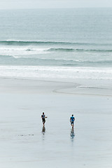 Image showing Surfers walking