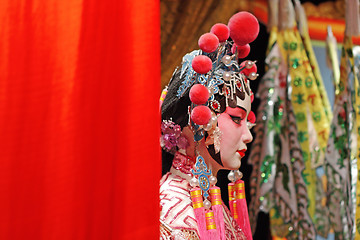 Image showing chinese opera dummy and red cloth as text space ,it is a toy,not