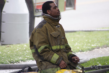 Image showing fireman kneeling